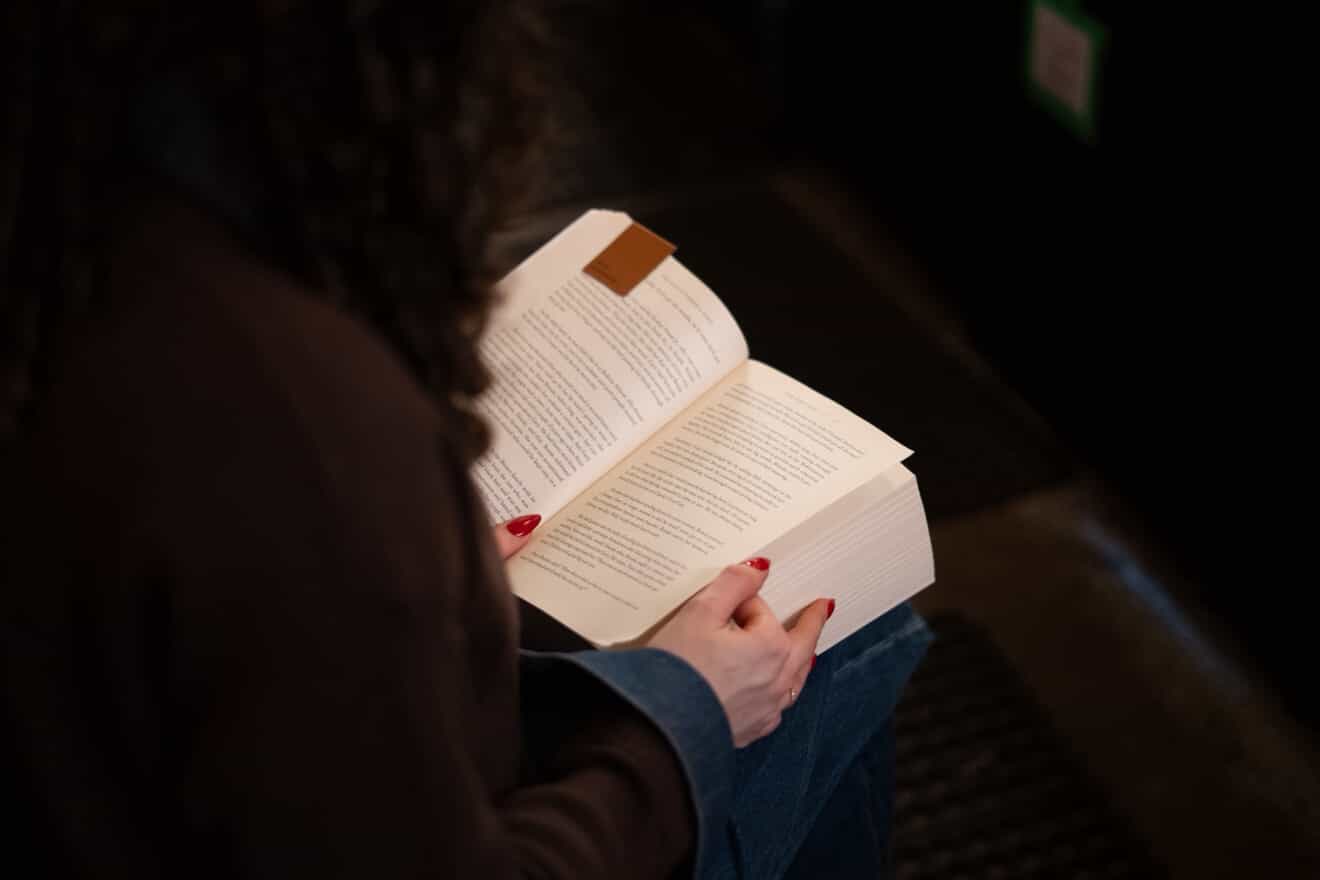 Close-up of an attendee reading a book during Quiet Reading Night